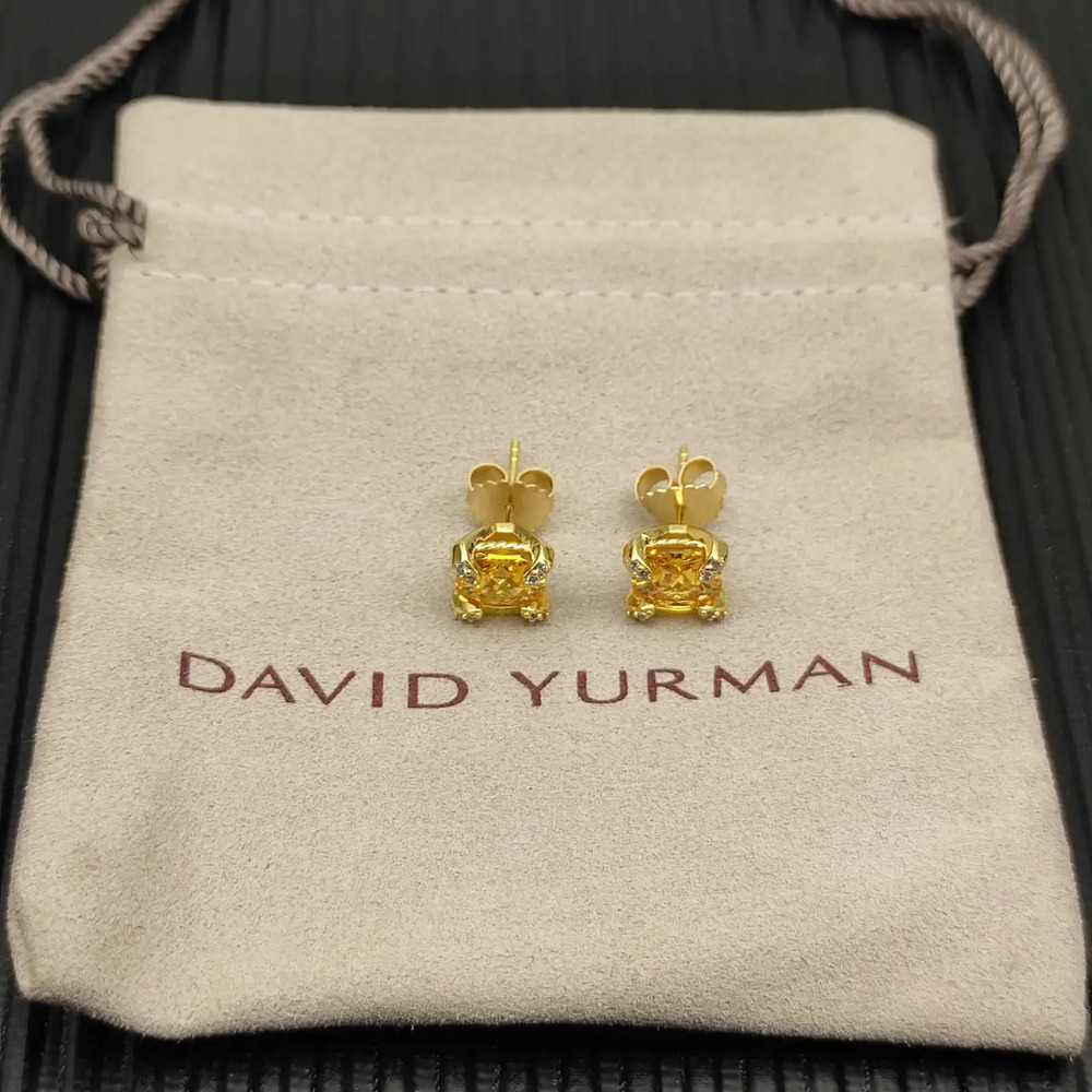 David Yurman four-prong earrings with a yellow diamond as the center stone